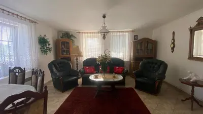 a living room with two chairs and a table at Chalupa u Marušky