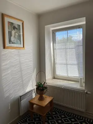a room with a window with a vase on a table at Chalupa u Marušky