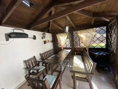 a dining room with a wooden table and chairs at Chalupa u Marušky