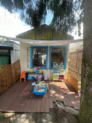 a childs play area in a backyard with a tree at Chatka Nová Živohošť in Křečovice