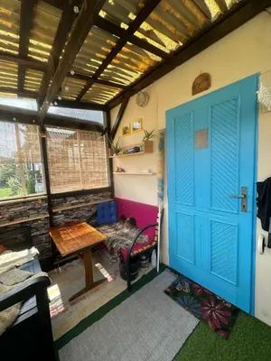 a room with a blue door and a table at Chatka Nová Živohošť in Křečovice