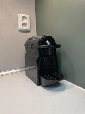 a black toaster sitting on a shelf next to a wall at Luxury Modern Apartment with View in Prague