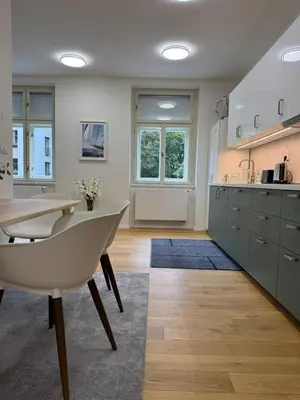 a kitchen with a table and a sink and a counter at Luxury Modern Apartment with View in Prague