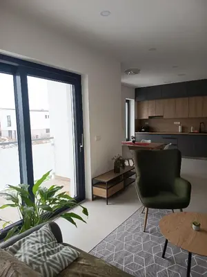 a living room with a couch and a table at Apartmány MB JARO Mladá Boleslav in Bradlec