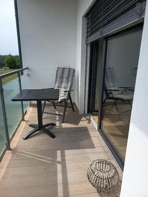 a chair and a table on the balcony of a building at Apartmány MB JARO Mladá Boleslav in Bradlec