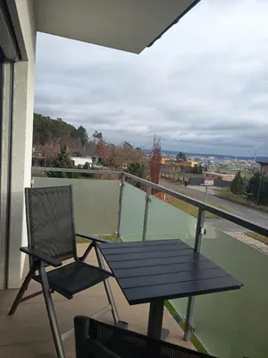 a picnic table and a chair on a balcony at Apartmány MB JARO Mladá Boleslav in Bradlec