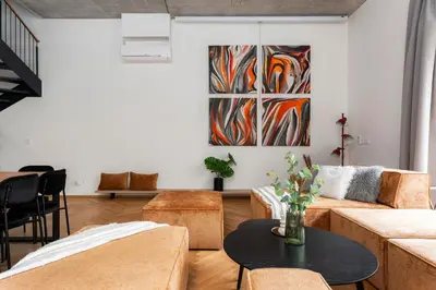 a living room with couches and a painting on the wall at Luxury Oomph Apartments in Prague
