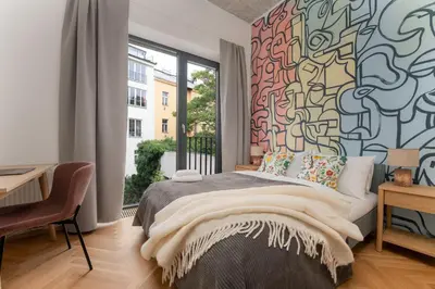 a bedroom with a bed and a large window at Luxury Oomph Apartments in Prague