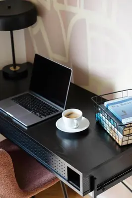a laptop computer sitting on a desk with a cup of coffee at Luxury Oomph Apartments in Prague