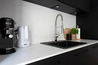 a kitchen counter with a sink and a coffee maker at Luxury Oomph Apartments in Prague