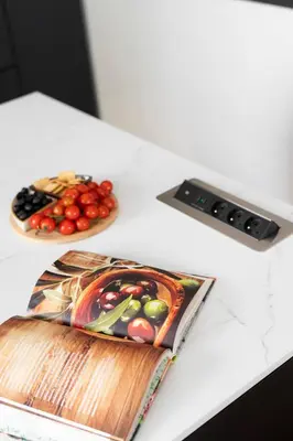 a table with two plates of fruit and a book at Luxury Oomph Apartments in Prague