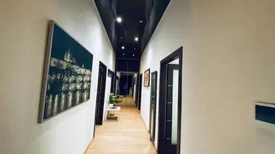 a hallway with paintings on the walls of a building at Emperor apartment in centre in Prague