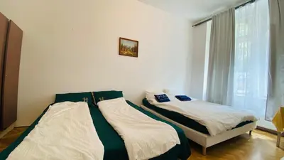 two beds sitting next to each other in a bedroom at Emperor apartment in centre in Prague