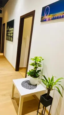 a white table with two potted plants on it at Emperor apartment in centre in Prague