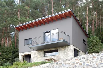 a house in the woods with a balcony at Chata Nola Slapy in Křečovice
