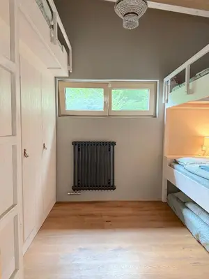 a room with two bunk beds and a window at Chata Nola Slapy in Křečovice