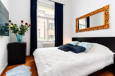 a bedroom with a bed with a mirror on the wall at Red Rose Residence in Prague
