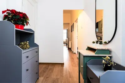 a bathroom with a blue dresser and a mirror at Red Rose Residence in Prague