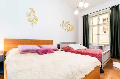 a bedroom with two beds and a window at Red Rose Residence in Prague