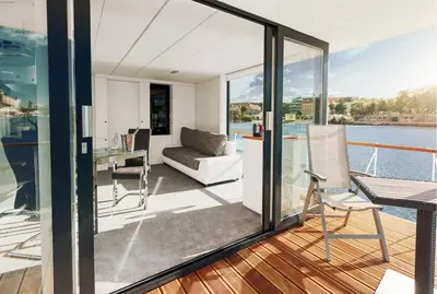 a view from the balcony of a house with a view of the water at VIPliving Houseboat in Prague