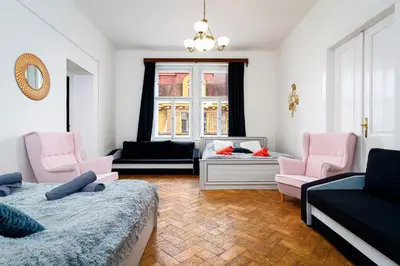a living room with two beds and two chairs at Victory Belle Maison in Prague