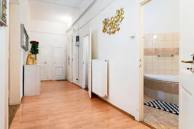 a bathroom with a tub and a toilet and a sink at Victory Belle Maison in Prague