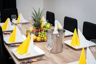 a long table with plates of fruit and wine glasses at Victory Belle Maison in Prague