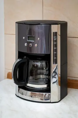 a black microwave oven sitting on top of a counter at Victory Belle Maison in Prague
