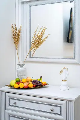 a plate of fruit on a dresser under a mirror at Victory Belle Maison in Prague