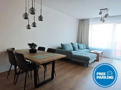 a living room with a table and a couch at Kolbenova Comfort Stay in Prague