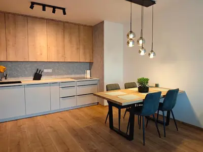 a kitchen and dining room with a table and chairs at Kolbenova Comfort Stay in Prague