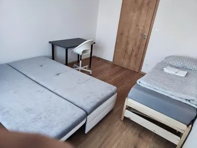 a bedroom with a bed with a green comforter at Kolbenova Comfort Stay in Prague