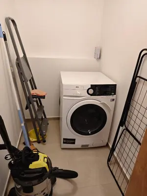a washer and dryer in a room with at Kolbenova Comfort Stay in Prague