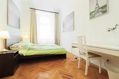 a small bedroom with a desk and a bed at Prague central 3&kk apartment Andel in Prague