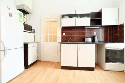 a kitchen with white cabinets and a refrigerator at Prague central 3&kk apartment Andel in Prague