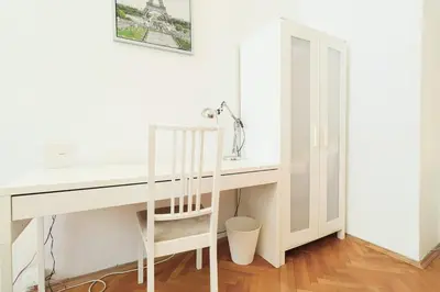 a white desk with a ladder next to a white wall at Prague central 3&kk apartment Andel in Prague