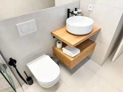a bathroom with a white sink and a toilet at New Modern Art Loft Apartment, City Center in Prague