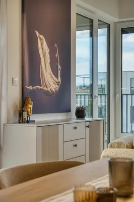a living room with a large painting on the wall at Chloé's Beige Apartment with big balcony, O2 arena in Prague