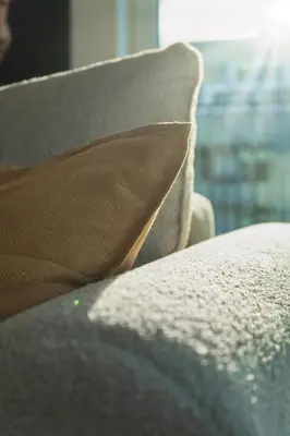 a pillow sitting on top of a couch with a window at Chloé's Beige Apartment with big balcony, O2 arena in Prague