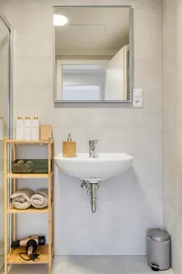 a bathroom with a sink and a mirror at Chloé's Beige Apartment with big balcony, O2 arena in Prague