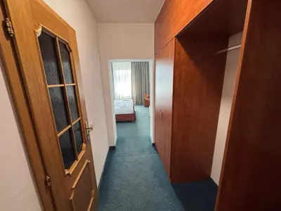 a hallway of a room with a door and a bedroom at Park Pension