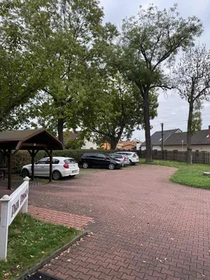 a group of cars parked in a parking lot at Park Pension