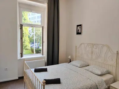 a bedroom with a bed and a window at Comfy 2 Bedrooms Flat 4 persons & Parking in Prague