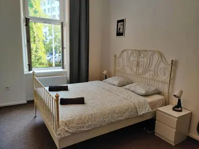 a bedroom with a bed and a large window at Comfy 2 Bedrooms Flat 4 persons & Parking in Prague