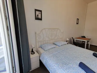 a bedroom with a bed and a desk and a table at Comfy 2 Bedrooms Flat 4 persons & Parking in Prague