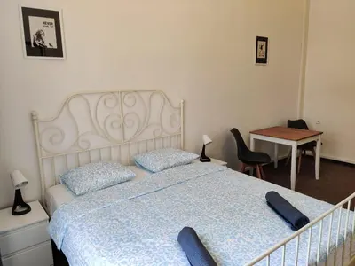 a bedroom with a bed and a desk and a table at Comfy 2 Bedrooms Flat 4 persons & Parking in Prague
