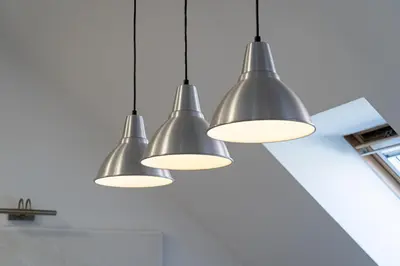 a group of three lights hanging from a ceiling at Brilliant Rabbit Residence in Prague