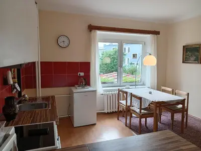 a kitchen and dining room with a table and a window at Apartmán Na Leštině in Příbram