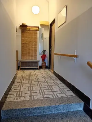 a hallway with a tile floor and a window at Apartmán Na Leštině in Příbram