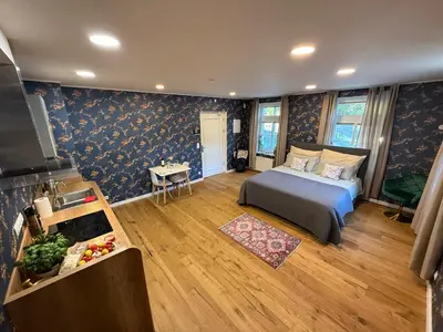 a bedroom with a bed in a room with blue wallpaper at Mulino Apartments